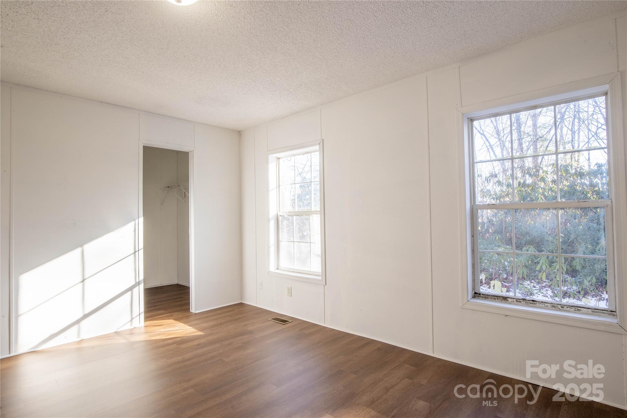 1960 Hanging Rock Road Spruce Pine, NC 28777 - Photo 35 of 47 a view of an empty room with wooden floor and a window