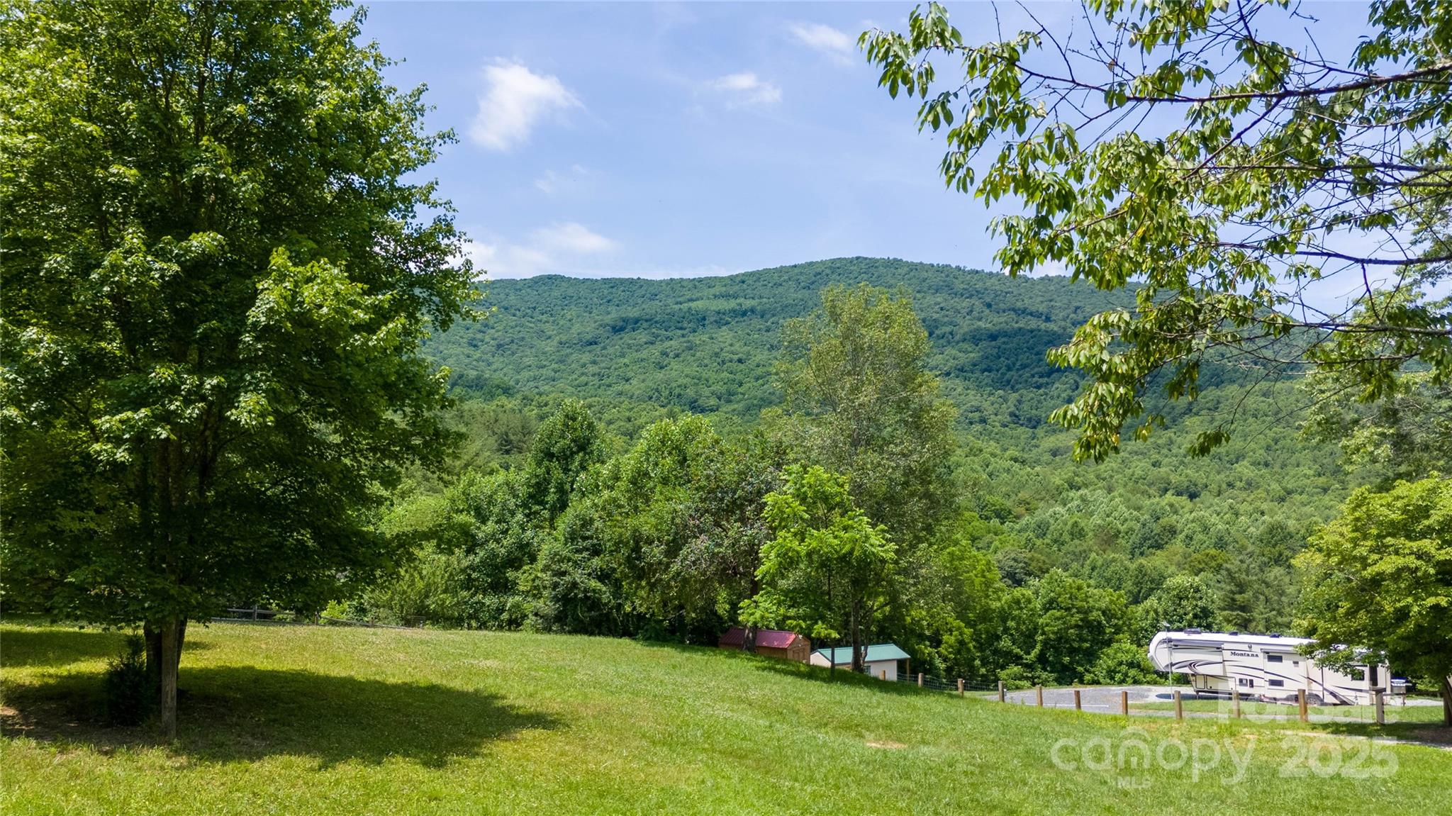 1960 Hanging Rock Road Spruce Pine, NC 28777 - Photo 9 of 47 a view of a garden with a building in the background