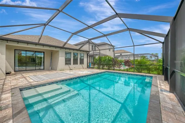 a view of a porch with chairs and backyard