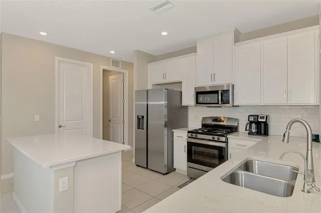 a kitchen with a sink cabinets and window