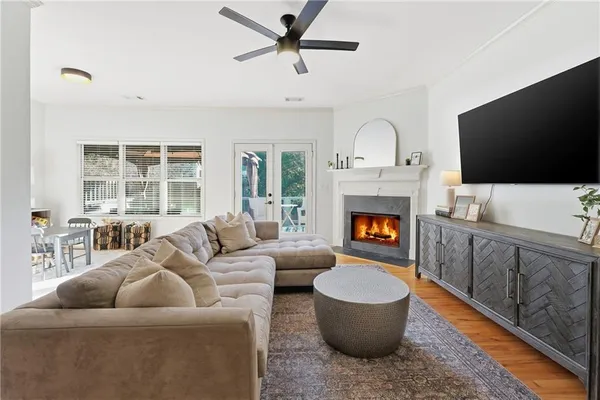 a living room with furniture a flat screen tv and a fireplace