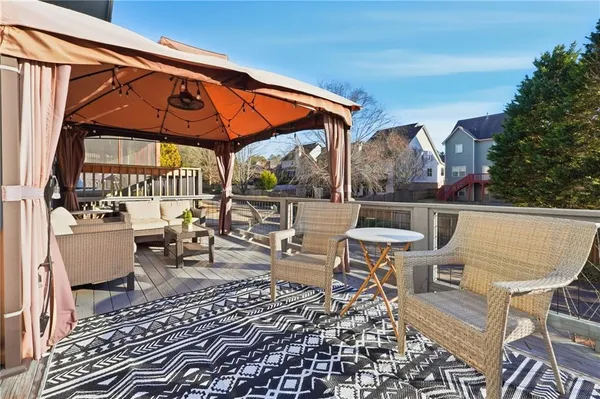 a outdoor space with the couches and dining table with the kitchen view