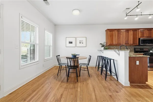a view of a dining room with furniture and wooden floor