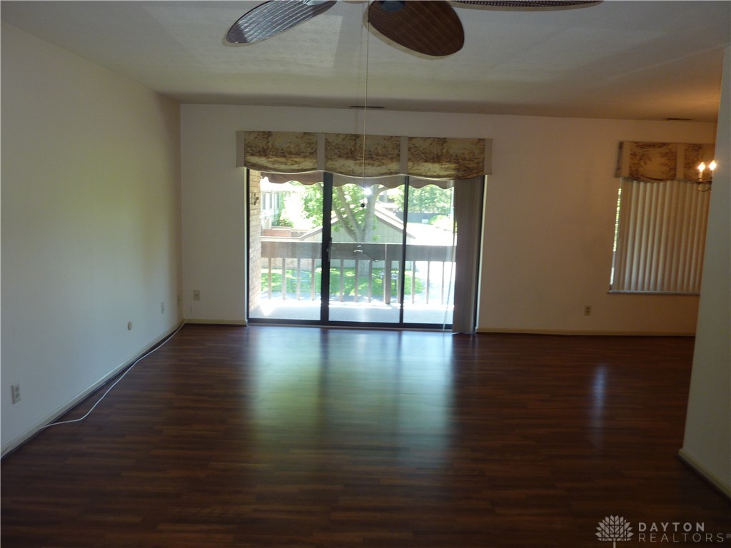 1345 Tattersall Road, Unit 64 Dayton, OH 45459 - Photo 4 of 25 Bright interior features wood flooring and access to an outdoor balcony, creating an inviting atmosphere.