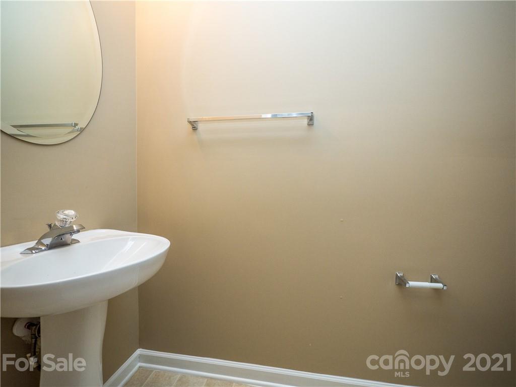 8178 Rudolph Road Charlotte, NC 28216 - Photo 13 of 20 a bathroom with a sink a mirror and a toilet