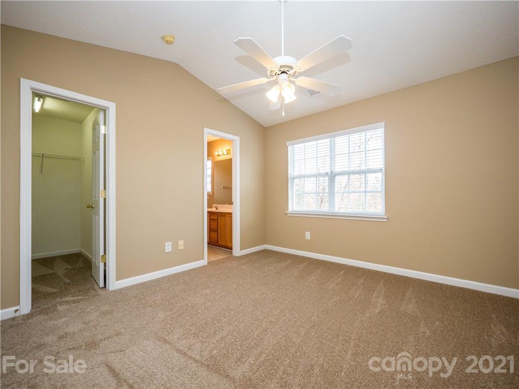 8178 Rudolph Road Charlotte, NC 28216 - Photo 14 of 20 an empty room with chandelier fan and windows