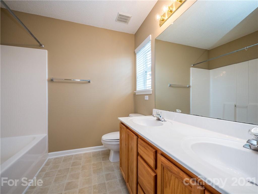 8178 Rudolph Road Charlotte, NC 28216 - Photo 15 of 20 a bathroom with a sink a toilet and shower