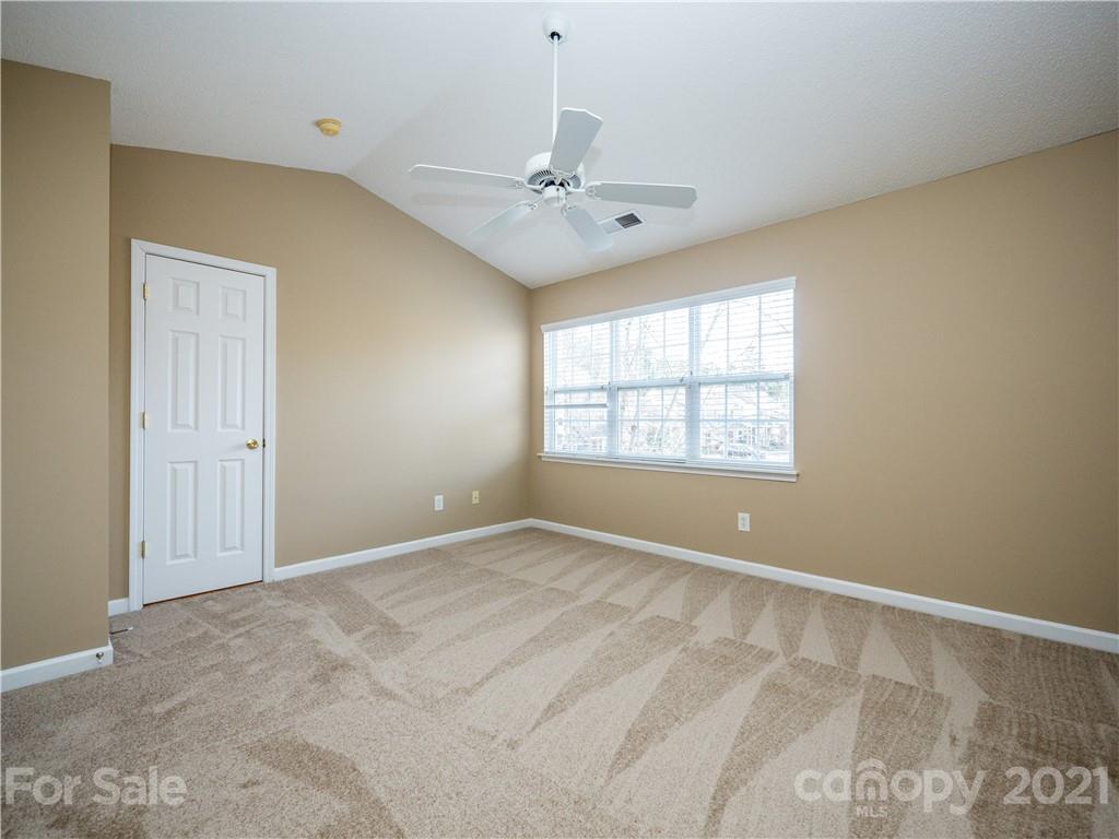 8178 Rudolph Road Charlotte, NC 28216 - Photo 16 of 20 an empty room with windows and fan