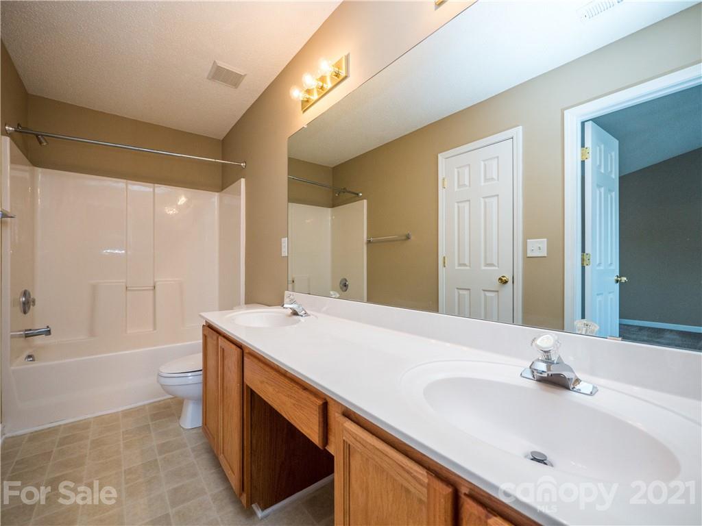 8178 Rudolph Road Charlotte, NC 28216 - Photo 17 of 20 a bathroom with a sink and a mirror