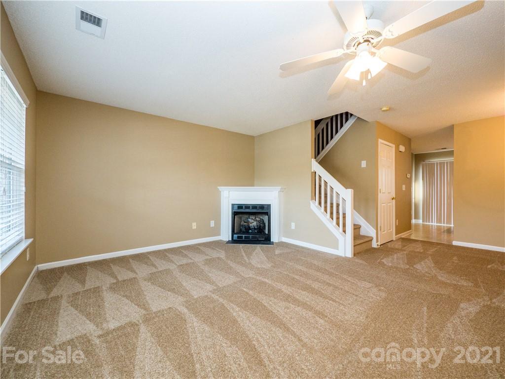 8178 Rudolph Road Charlotte, NC 28216 - Photo 4 of 20 a view of a big room with closet and a ceiling fan
