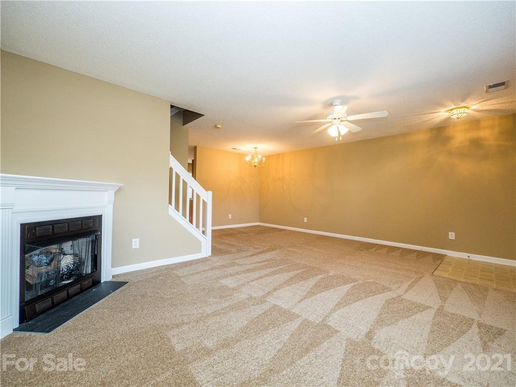 8178 Rudolph Road Charlotte, NC 28216 - Photo 5 of 20 a view of an empty room with a fireplace