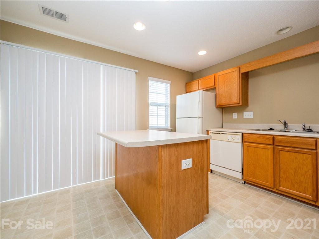 8178 Rudolph Road Charlotte, NC 28216 - Photo 9 of 20 a kitchen with stainless steel appliances granite countertop a stove a sink and a refrigerator