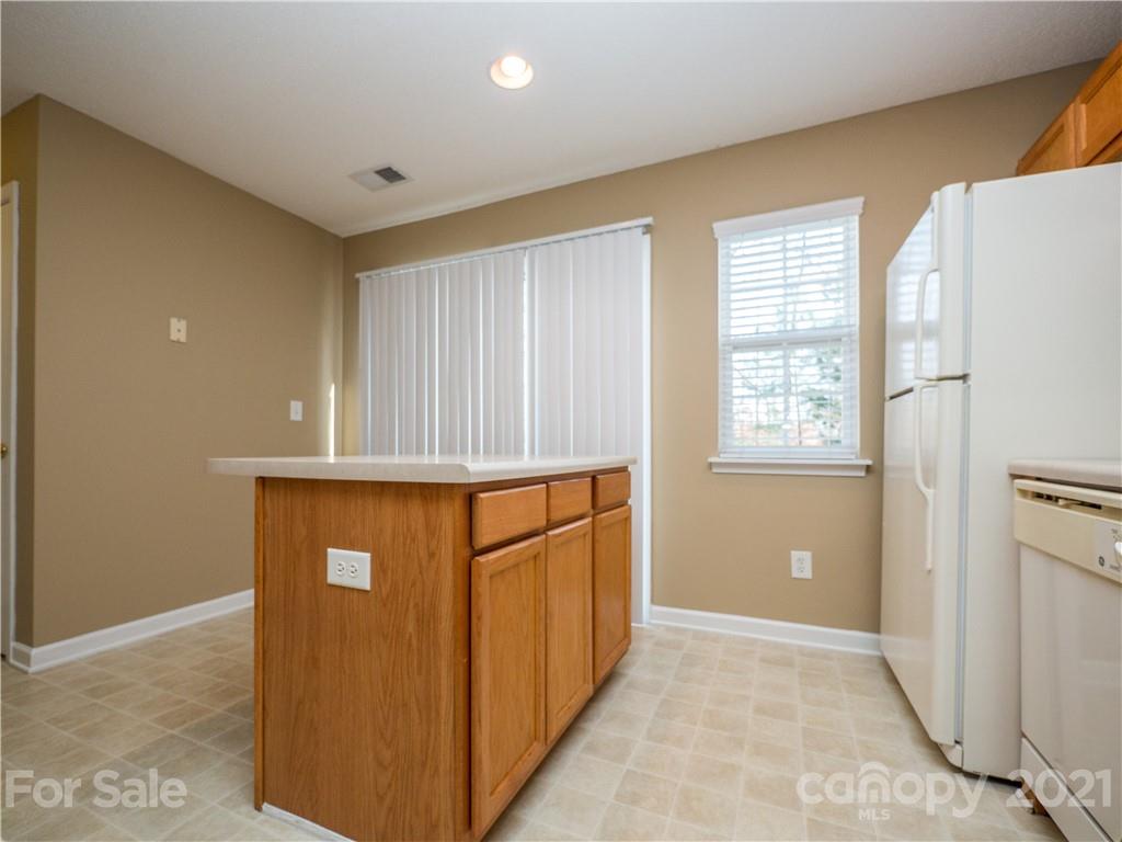 8178 Rudolph Road Charlotte, NC 28216 - Photo 10 of 20 a view of an empty room with windows & cabinet