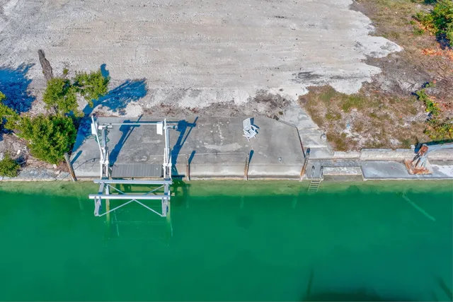 a view of a backyard with table and chairs with wooden fence