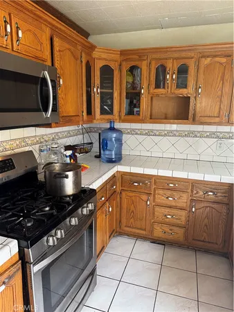 a kitchen with stainless steel appliances granite countertop a sink and cabinets