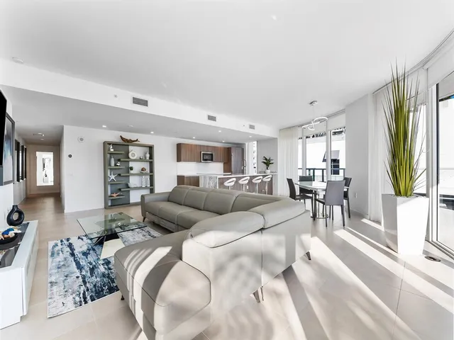a large kitchen with a large counter top appliances and cabinets