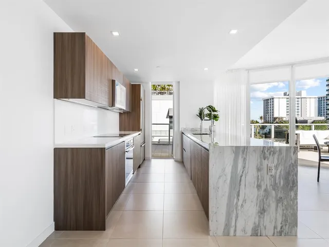 a kitchen with a sink and a stove top oven