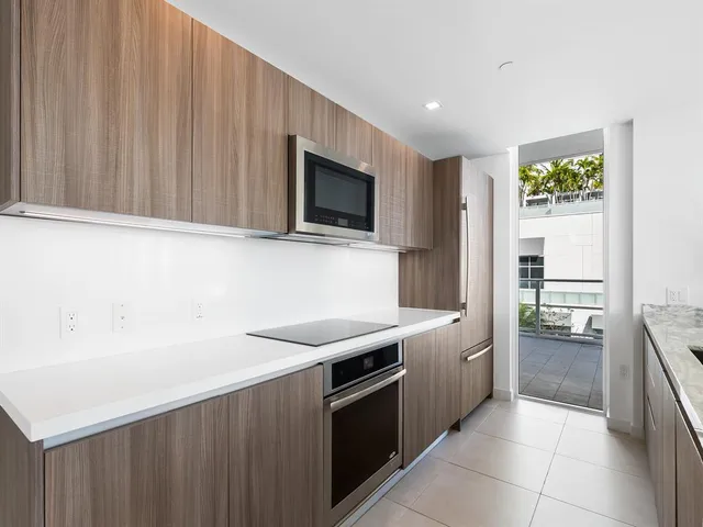 a kitchen with stainless steel appliances wooden cabinets and sink