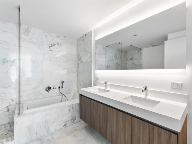 a spacious bathroom with a shower and a sink