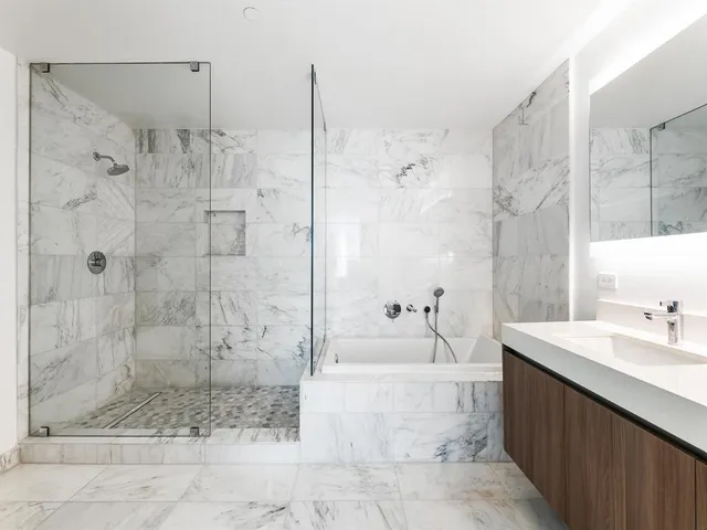 a bedroom with a bed flat screen tv and window