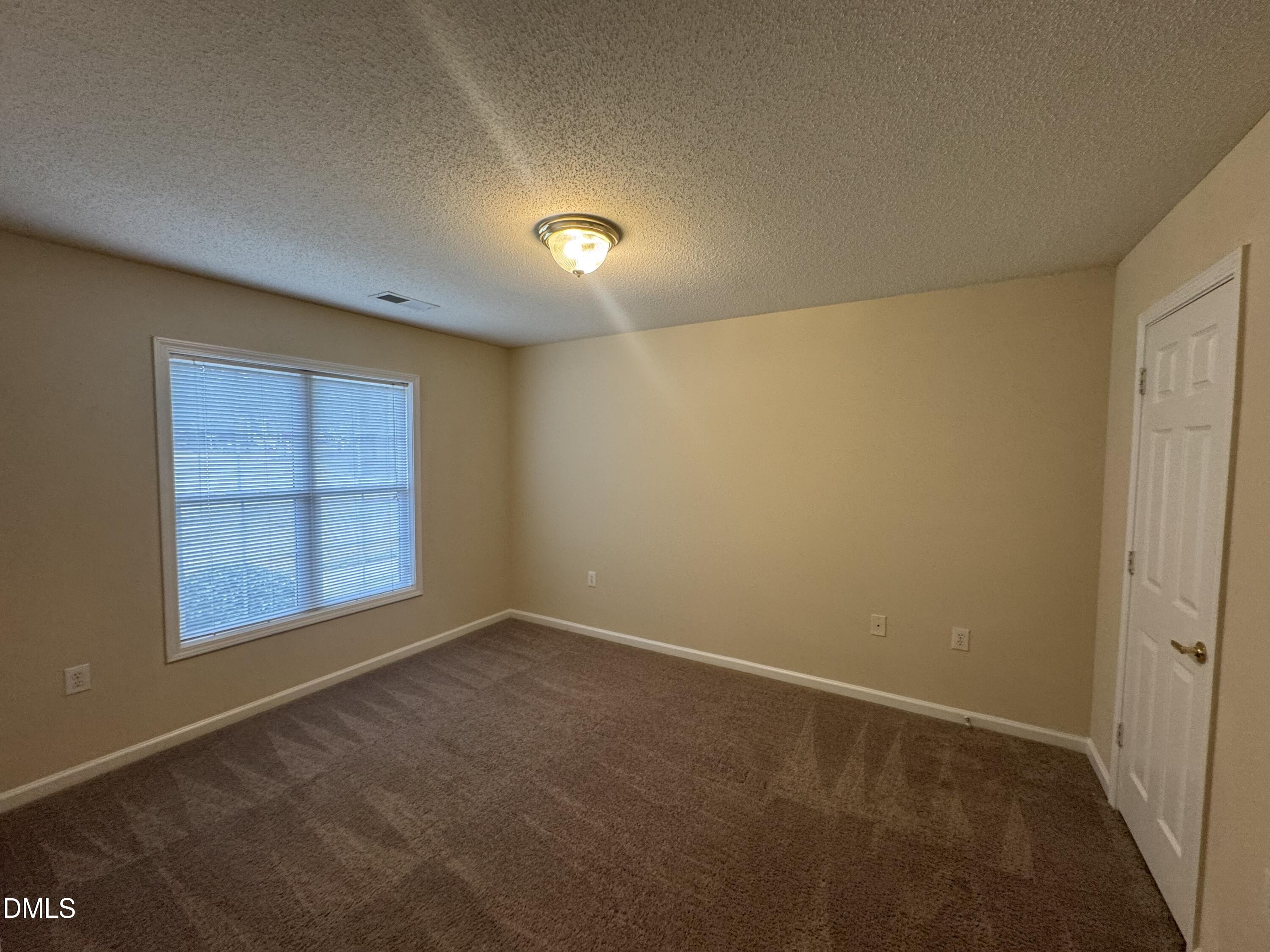 Undisclosed Address Raleigh, NC 27617 - Photo 7 of 22 an empty room with a window