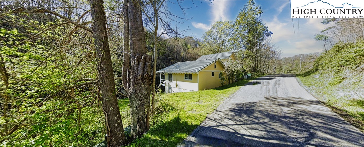 232 Cole Hollow Road Newland, NC 28657 - Photo 2 of 31 a view of a house with a small yard