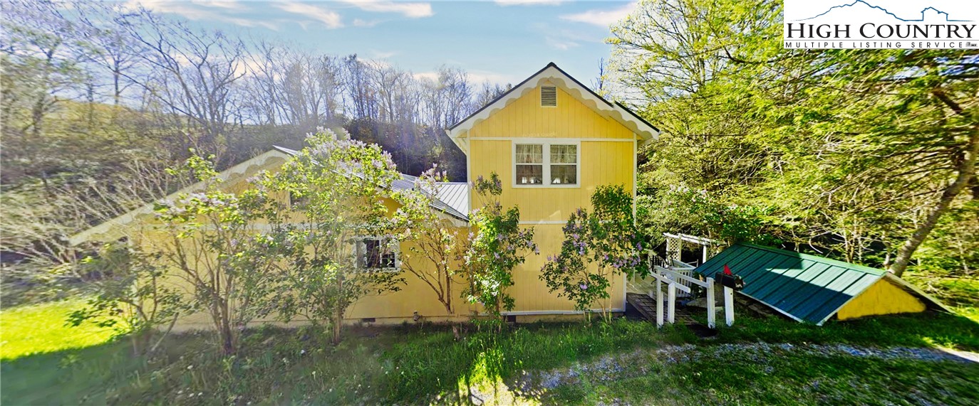232 Cole Hollow Road Newland, NC 28657 - Photo 31 of 31 a view of a house with a yard and sitting area