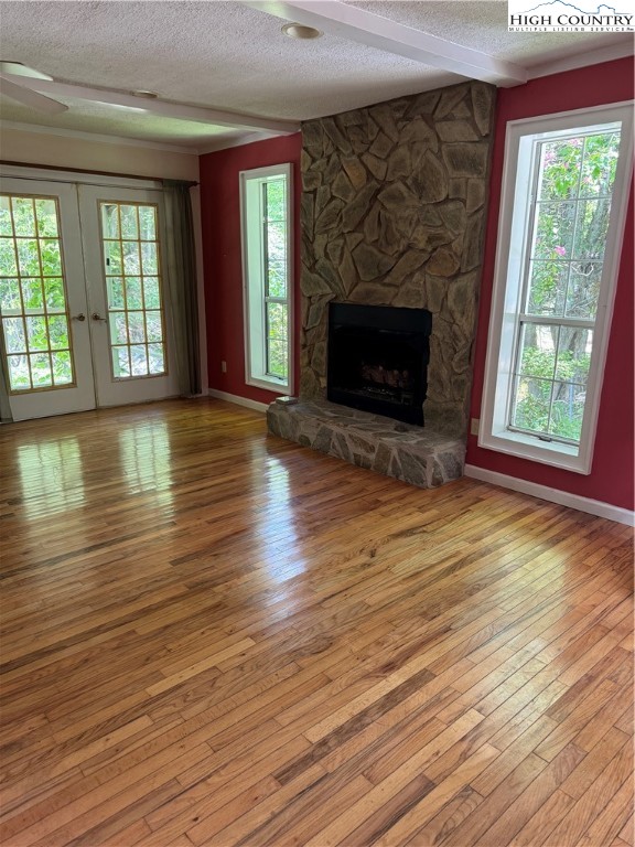 232 Cole Hollow Road Newland, NC 28657 - Photo 10 of 31 wooden floor fireplace and windows in an empty room