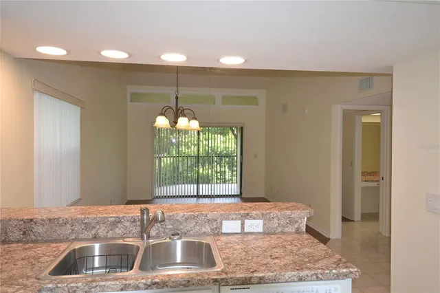 a kitchen with a sink and a granite counter tops