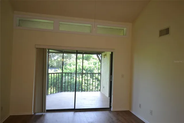 a view of an empty room and wooden floor
