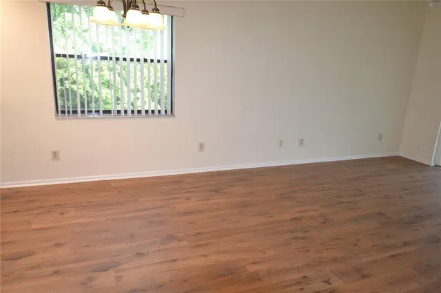 a view of staircase with wooden floor and windows