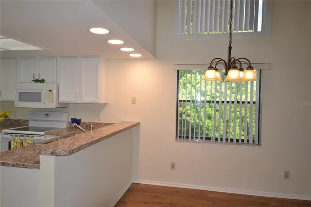 a kitchen with a sink window and cabinets