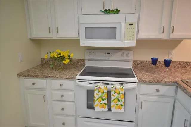 a stove top oven sitting inside of a kitchen