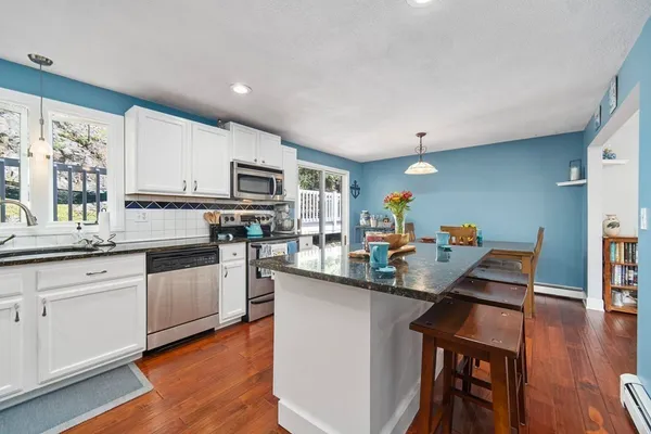 a kitchen with white cabinets and appliances