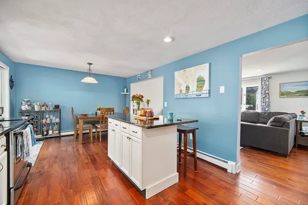 a view of a living room filled with furniture and wooden floor