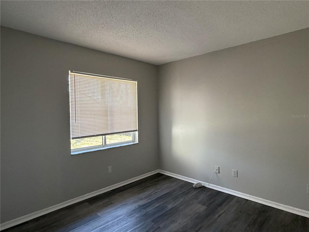 1215 Ravida Circle Orlando, FL 32825 - Photo 11 of 22 an empty room with wooden floor and windows
