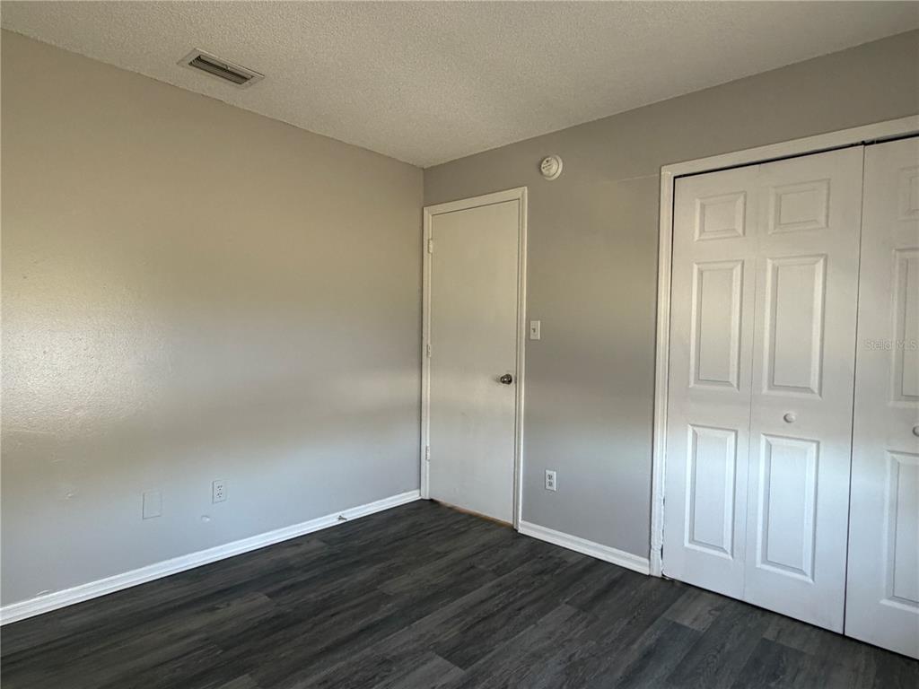 1215 Ravida Circle Orlando, FL 32825 - Photo 12 of 22 a view of an empty room with wooden floor and closet area