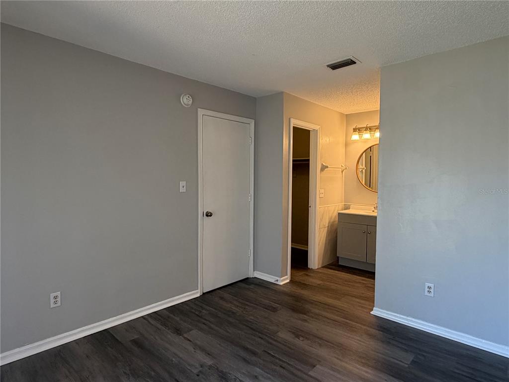 1215 Ravida Circle Orlando, FL 32825 - Photo 15 of 22 a view of an empty room with wooden floor and closet