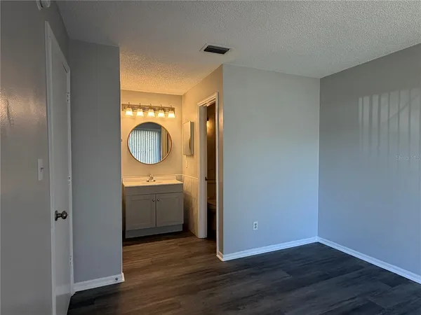 a view of a bathroom with a sink and a mirror