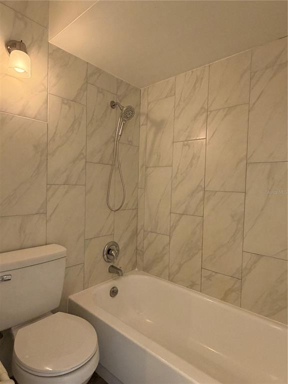 1215 Ravida Circle Orlando, FL 32825 - Photo 17 of 22 a white bath tub sitting next to a white toilet and sink