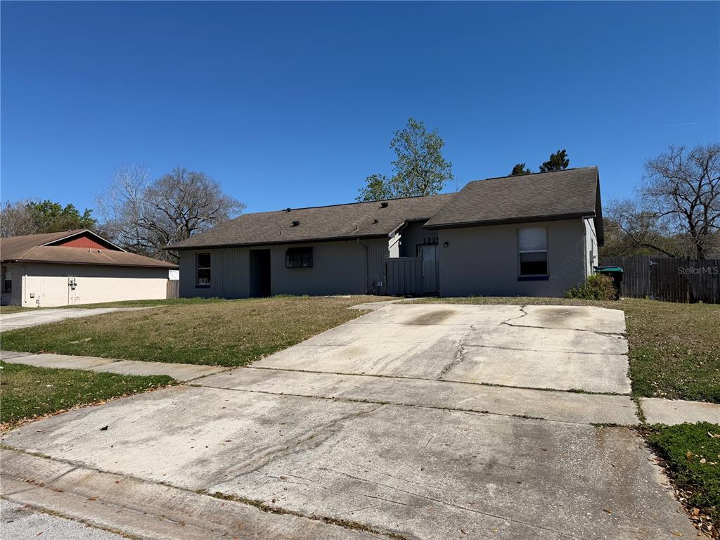 1215 Ravida Circle Orlando, FL 32825 - Photo 2 of 22 a front view of a house with a yard
