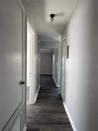 a view of a hallway with the wooden floor