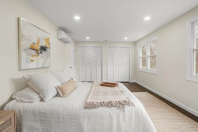 a spacious bedroom with a large bed and a window