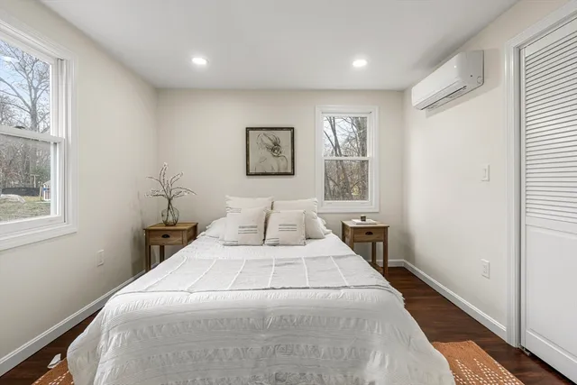 a bedroom with a large bed and a window