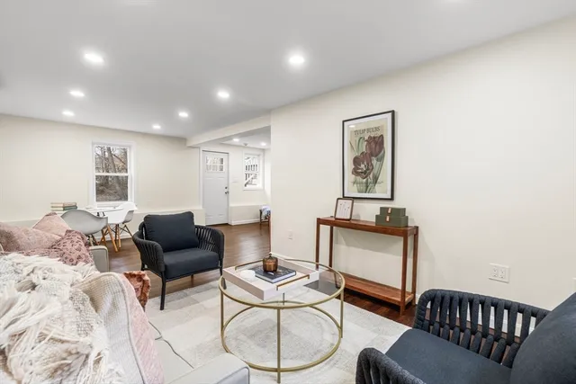 a living room with furniture and wooden floor