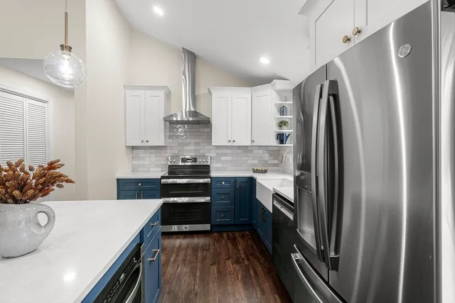 a kitchen with stainless steel appliances a refrigerator sink and stove