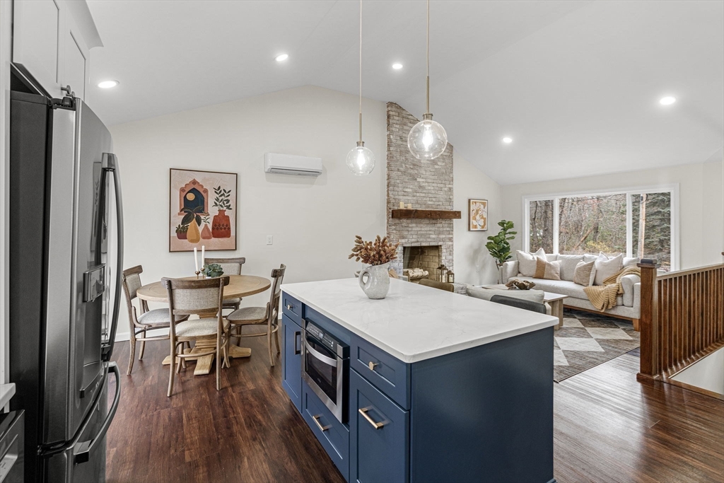 7 Old North Road Hudson, MA 01749 - Photo 8 of 39 a living room with stainless steel appliances furniture a rug and a kitchen view