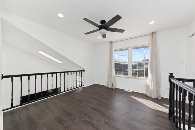 a view of a livingroom with a hardwood floor and window