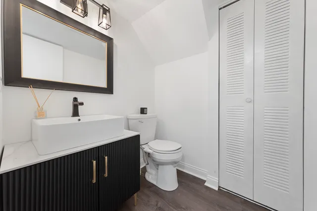 a bathroom with a toilet sink and mirror