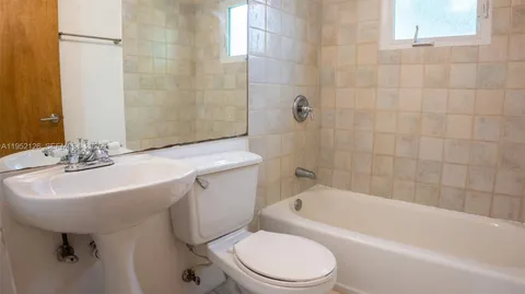 a bathroom with a sink a toilet and bathtub